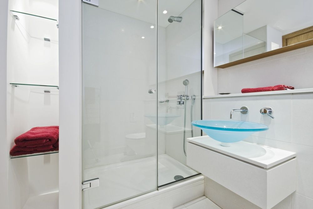A Bathroom With A Glass Shower Door And A Sink — InStyle Shower Screens & Wardrobes in Newcastle, NSW