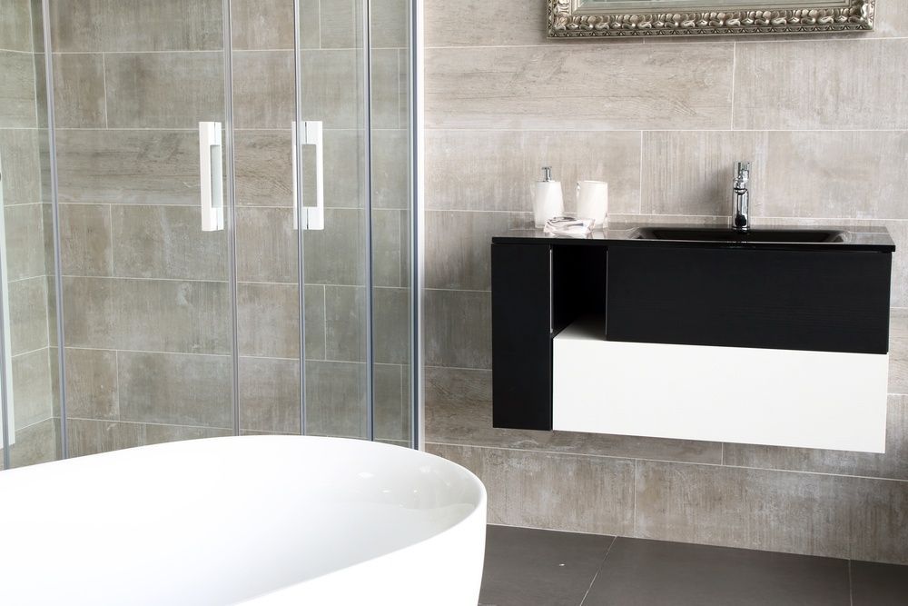 A Bathroom With A Bathtub A Sink And A Shower Stall — InStyle Shower Screens & Wardrobes in Wyong, NSW