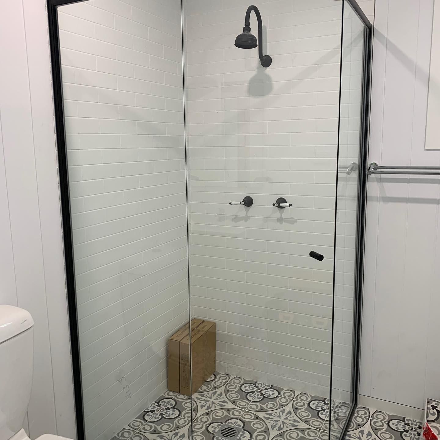 A Bathroom With A Toilet, Shower, And Shower Head — InStyle Shower Screens & Wardrobes in Charmhaven, NSW