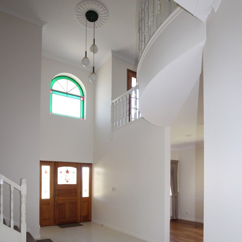 A Big White Living Room Of A Big House And Ceiling Lamp — Leader Constructions in Cranbrook, QLD
