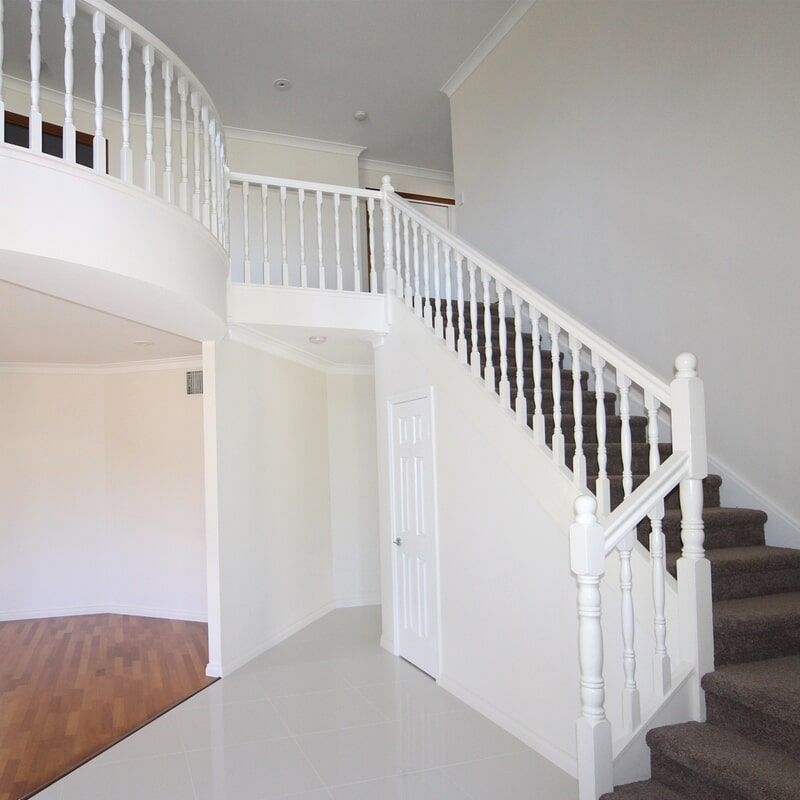 A Staircase with A White Railing Leading up To the Second Floor — Leader Constructions in Cranbrook, QLD