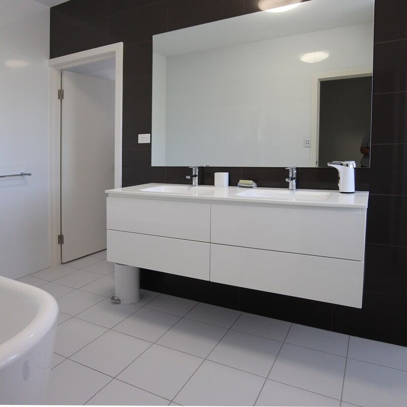 A Bathroom with Two Sinks and A Large Mirror — Leader Constructions in Cranbrook, QLD