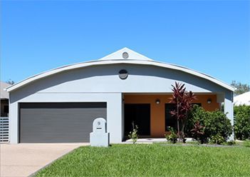 A House with A Curved Roof and Two Garage Doors — Leader Constructions in Cranbrook, QLD