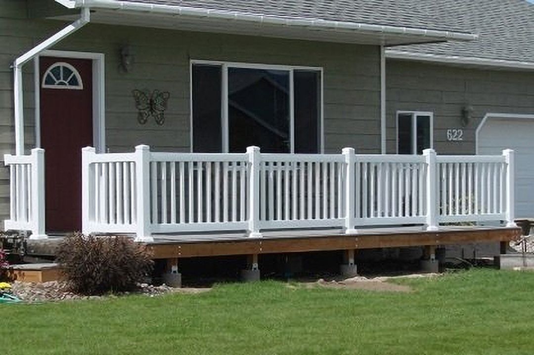 A house with a white porch and a red door