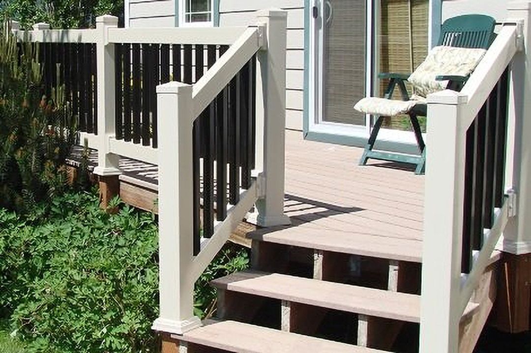 A deck with stairs leading up to it and a chair on it.