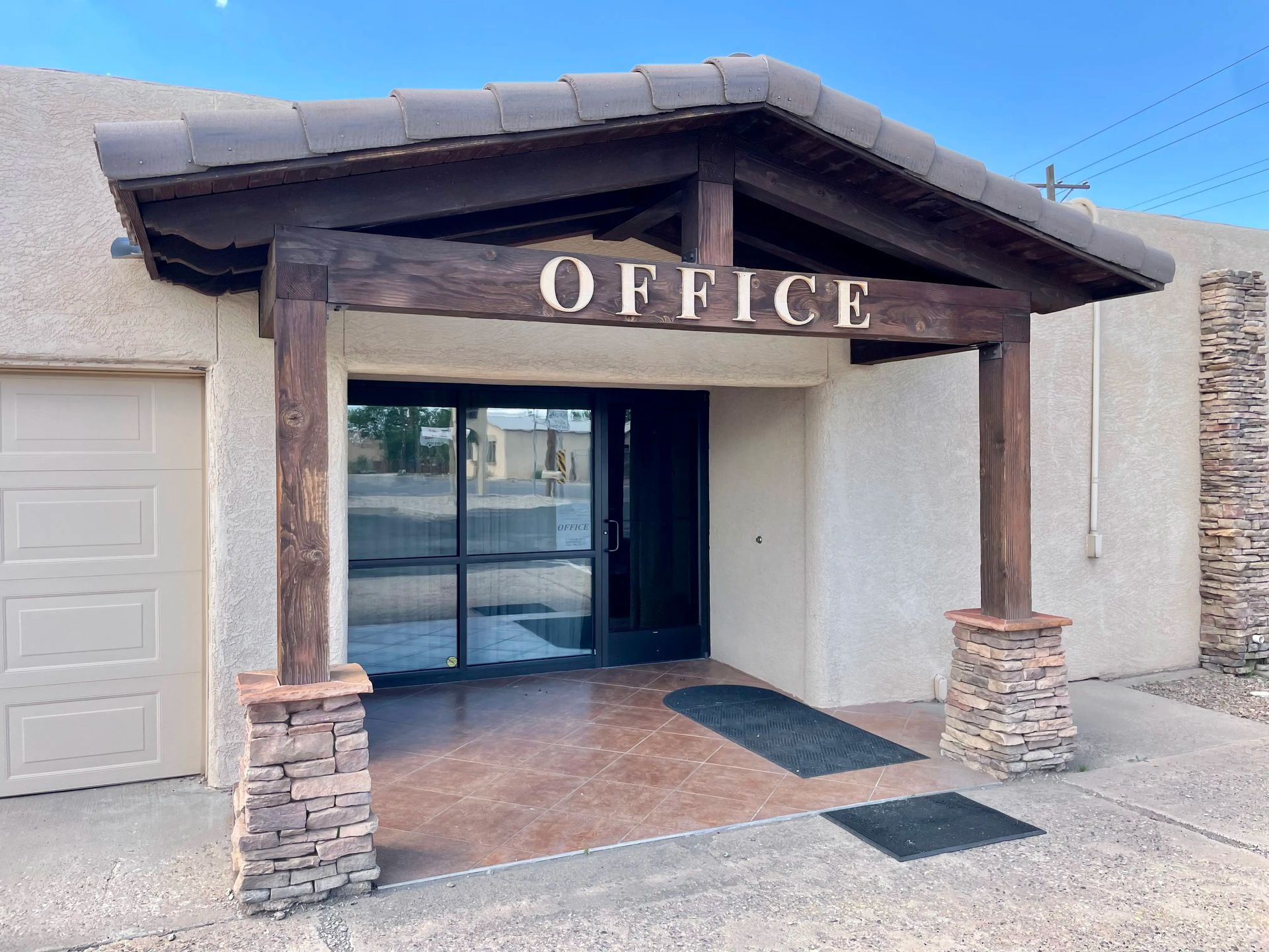 Office entrance with brown wooden supports and 