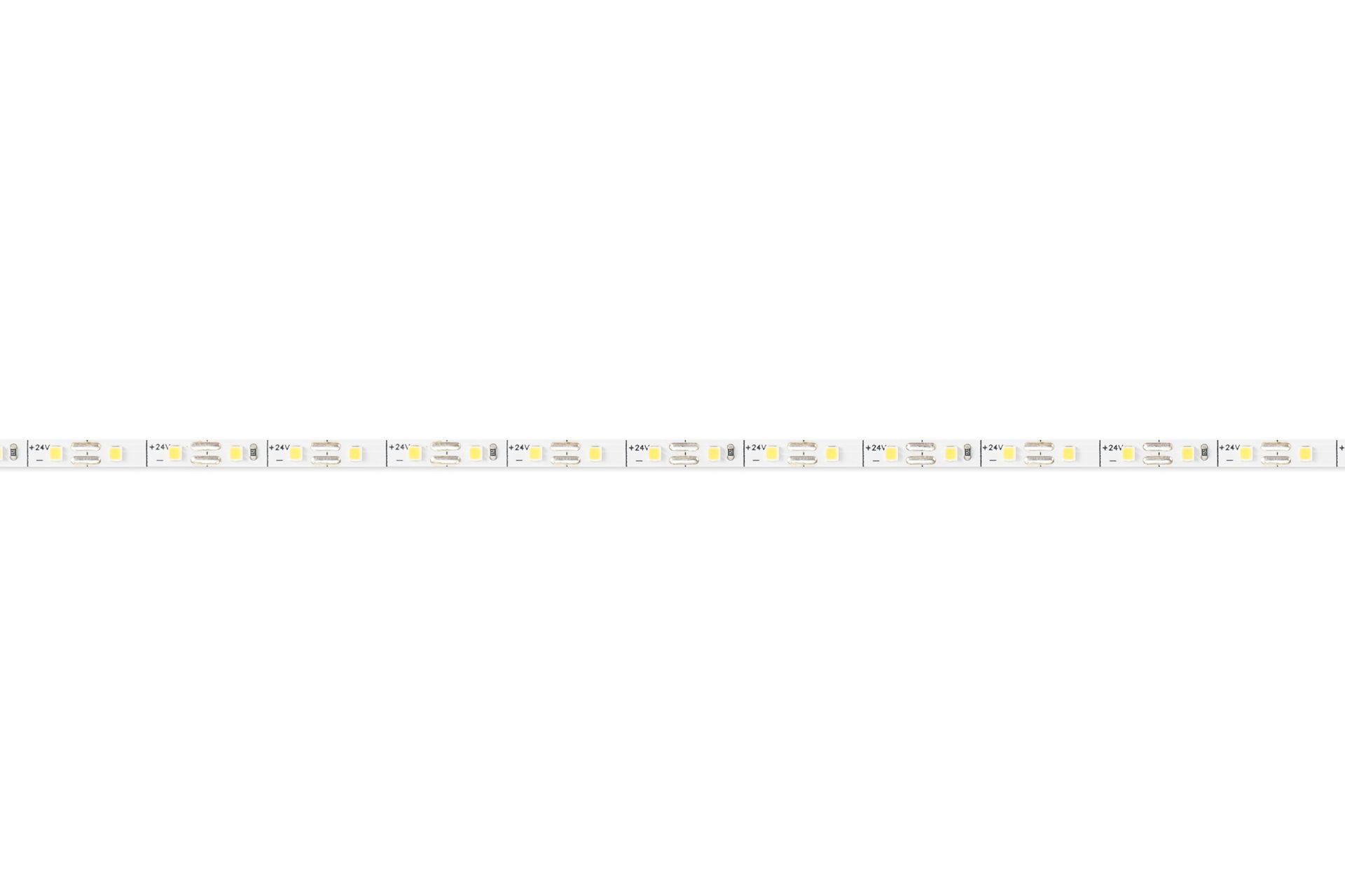 LED light strip with adhesive backing, coiled on a white surface.