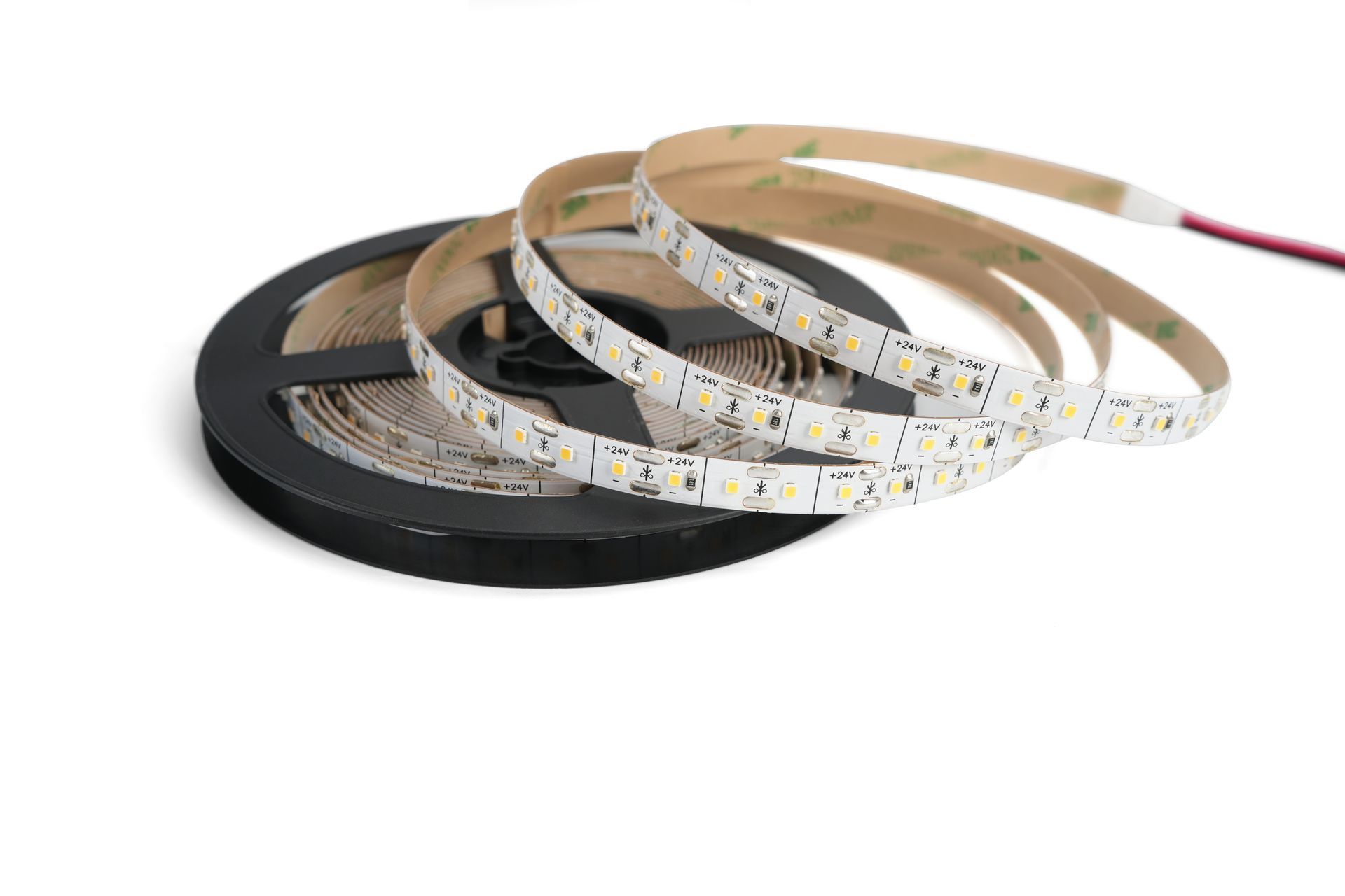 LED strip light on a black spool, partially unrolled, with red and black wires.