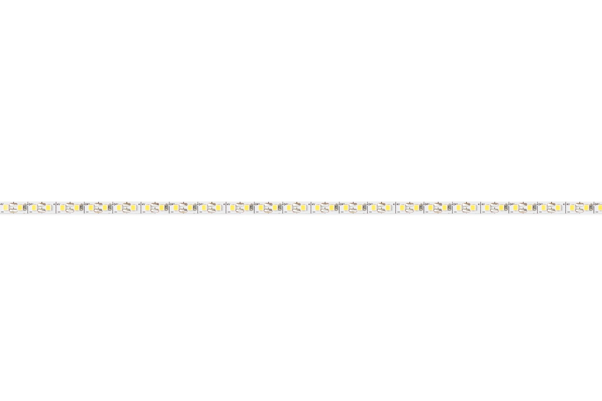 LED light strip coiled on a white surface, showing adhesive backing.