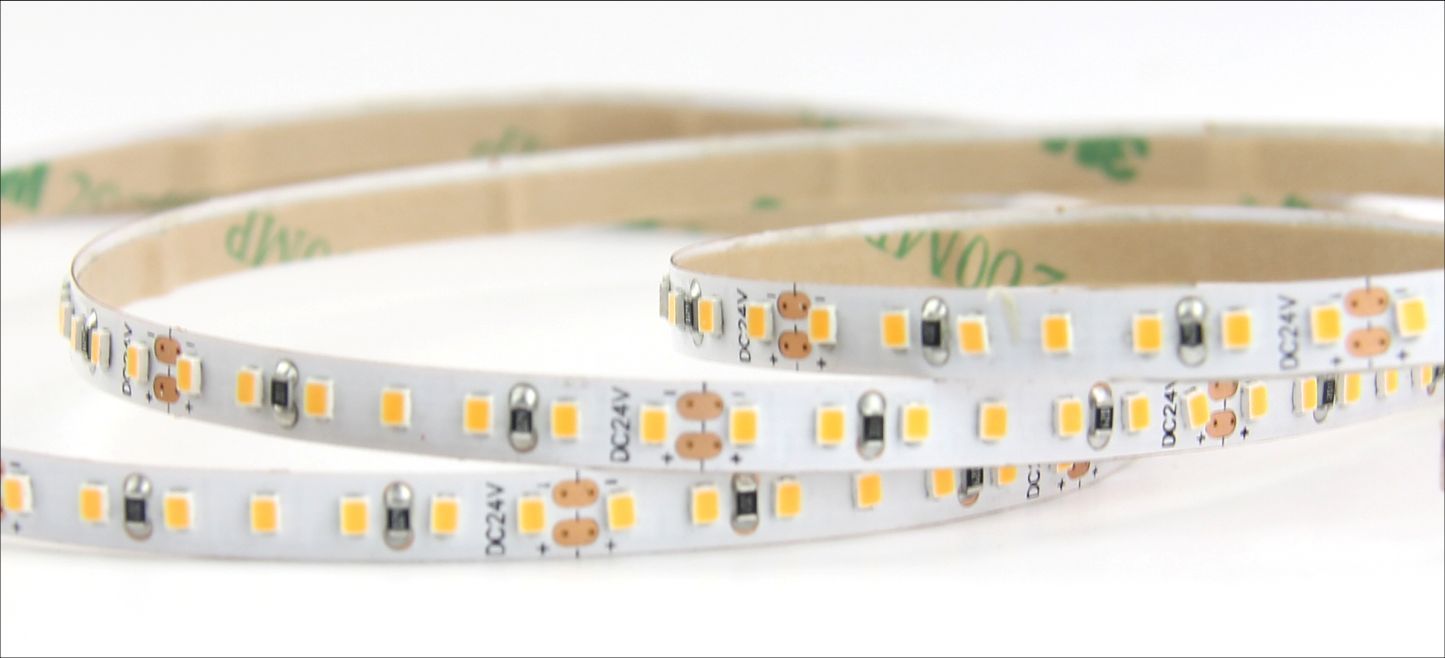 LED strip light, white with yellow LEDs, coiled on a white background.