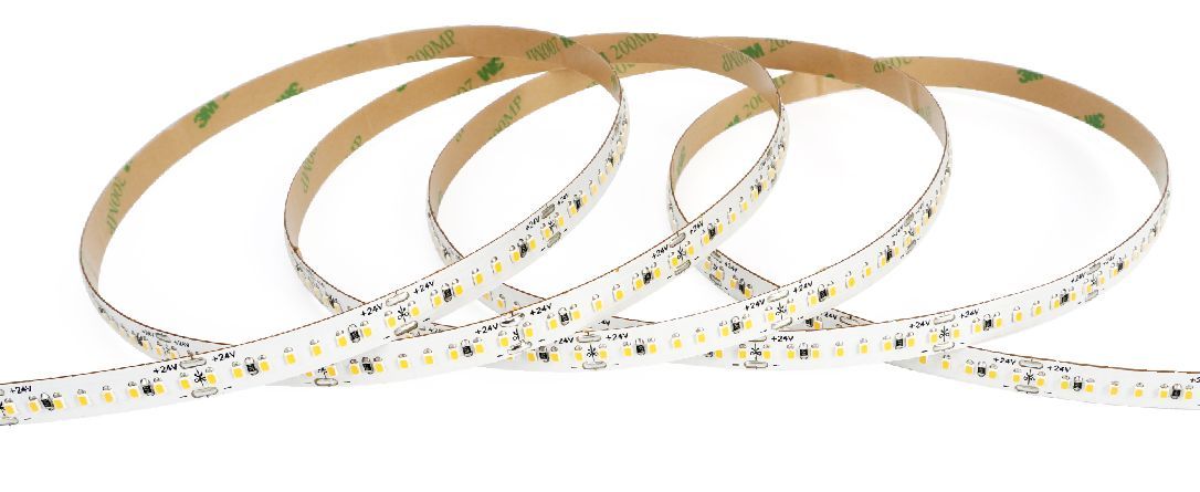 Flexible LED strip lights with adhesive backing, coiled on a white surface.