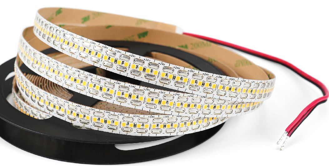 LED light strip on a spool with red and black wires.