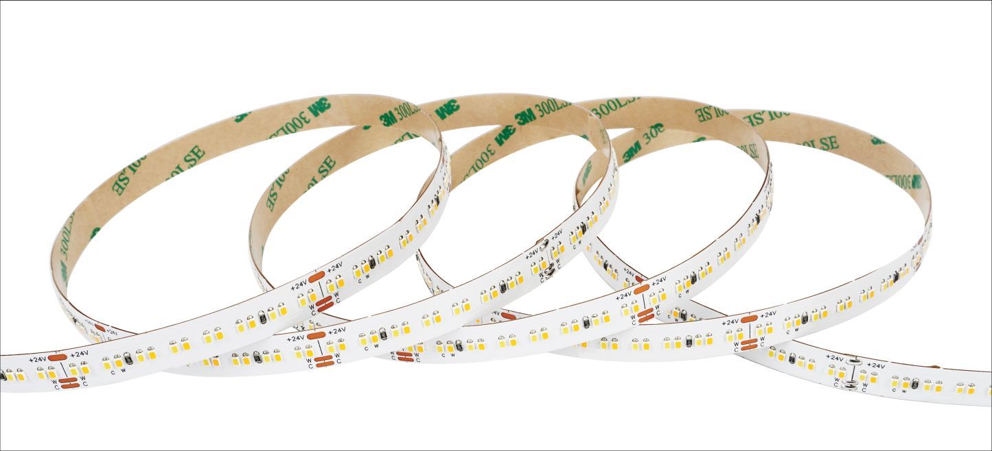 LED light strip with adhesive backing, coiled on a white surface.