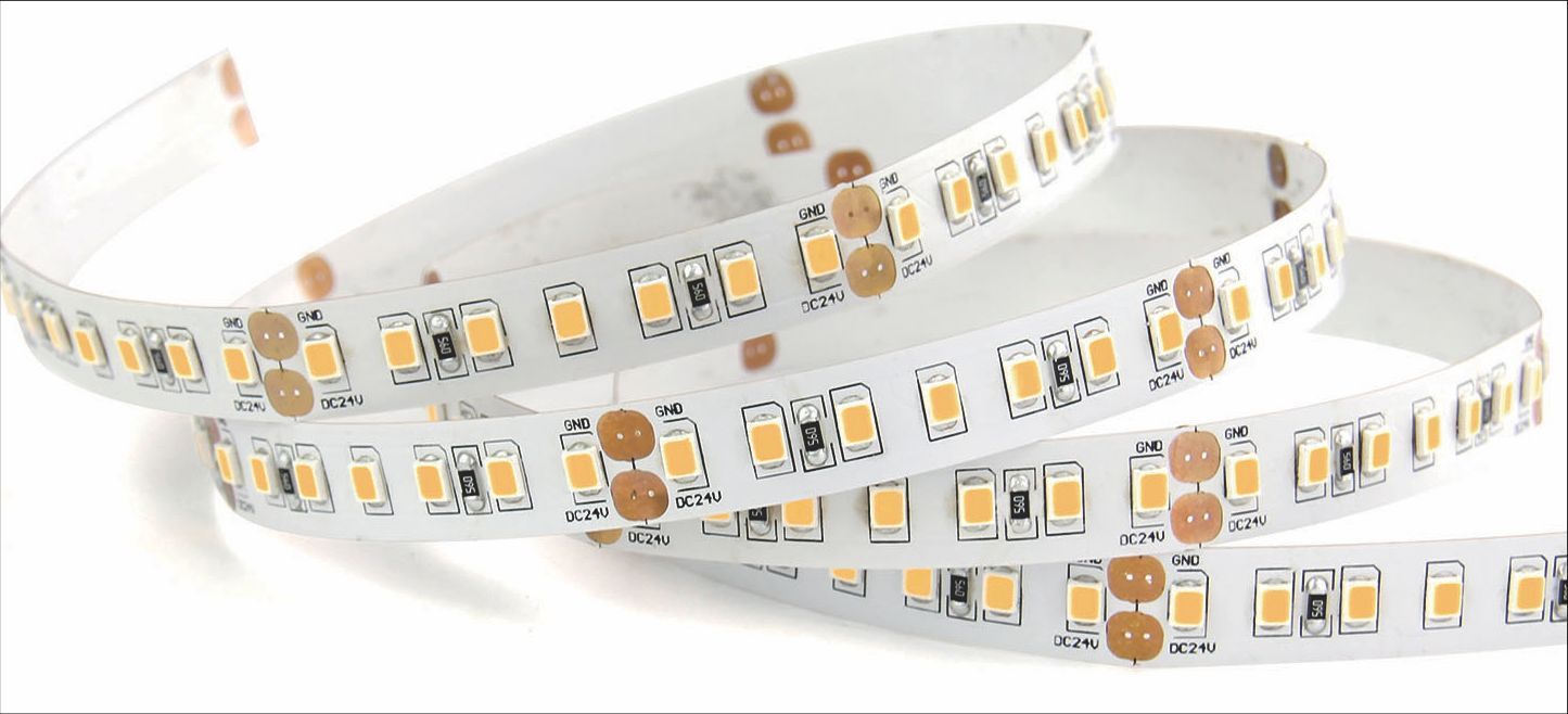 LED light strip coiled, white with small yellow lights, on a white background.