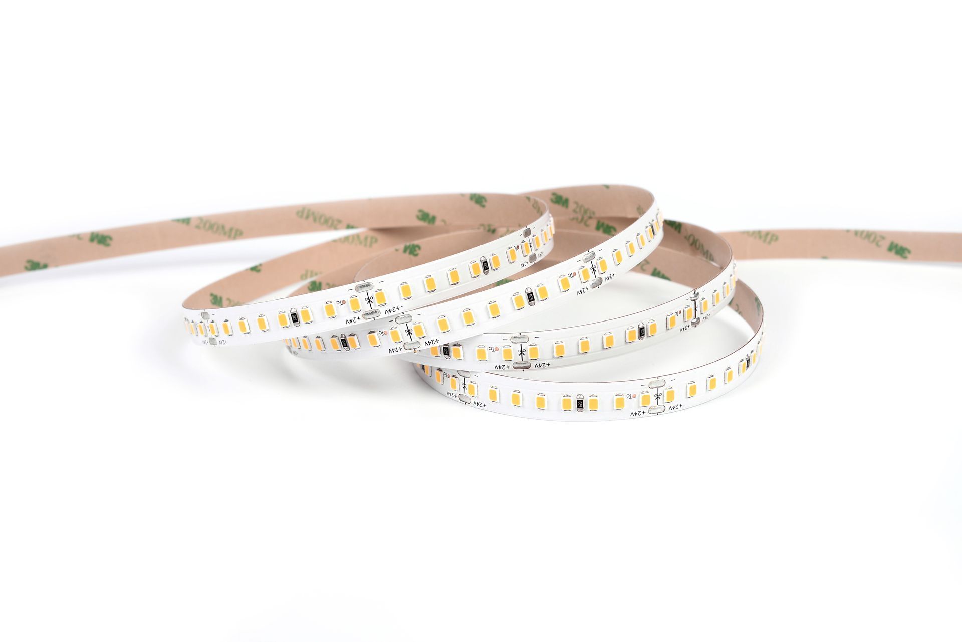 LED strip lights, coiled on a white background, showing the adhesive backing.