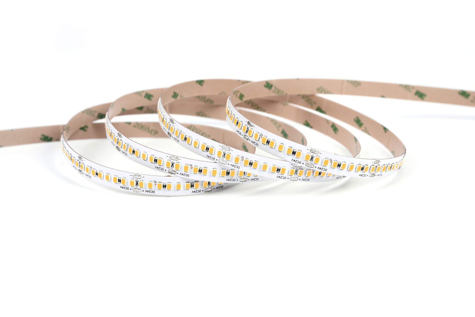 Flexible LED light strip, rolled up on white background, adhesive backing visible.