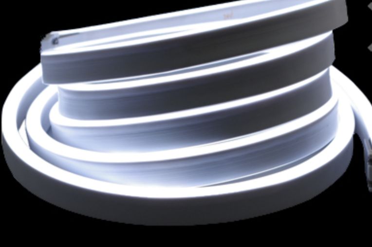 Coiled white flexible LED strip light; black background.