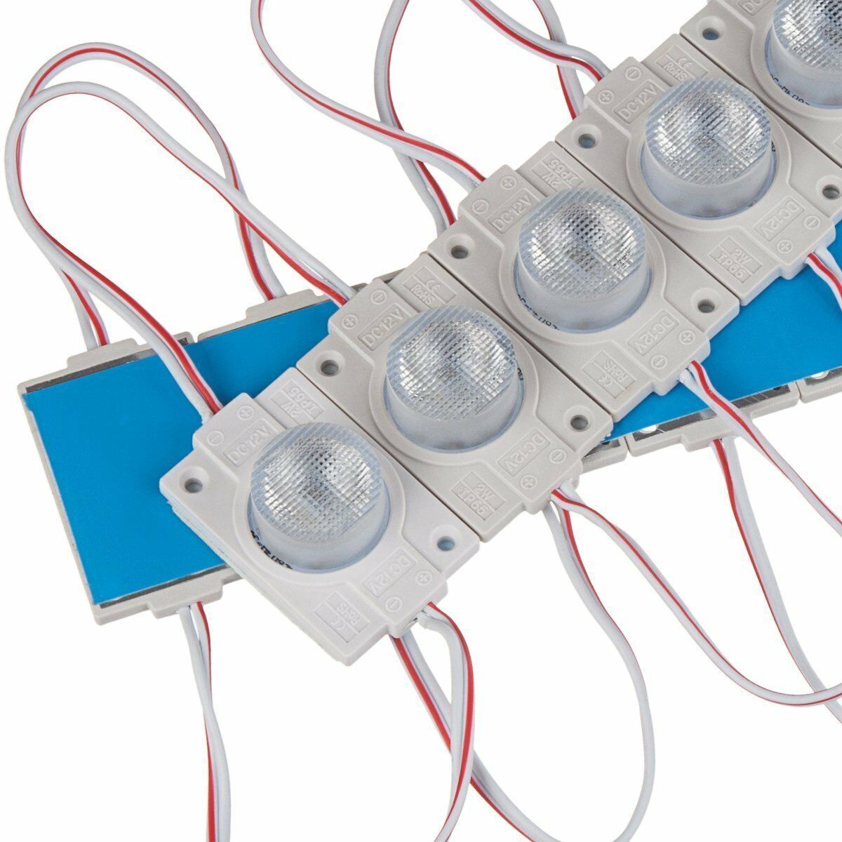 White LED modules with clear dome lenses and red/white wires. Blue adhesive backing visible.