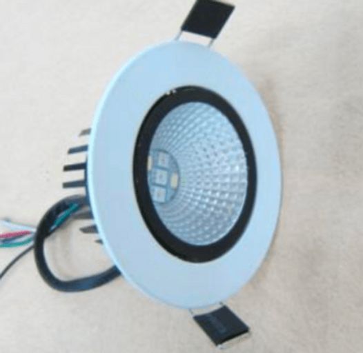 White recessed LED spotlight with black interior and heat sink, wires attached.