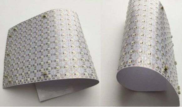 Two flexible white light panels with many small LEDs, curved to show their flexibility.