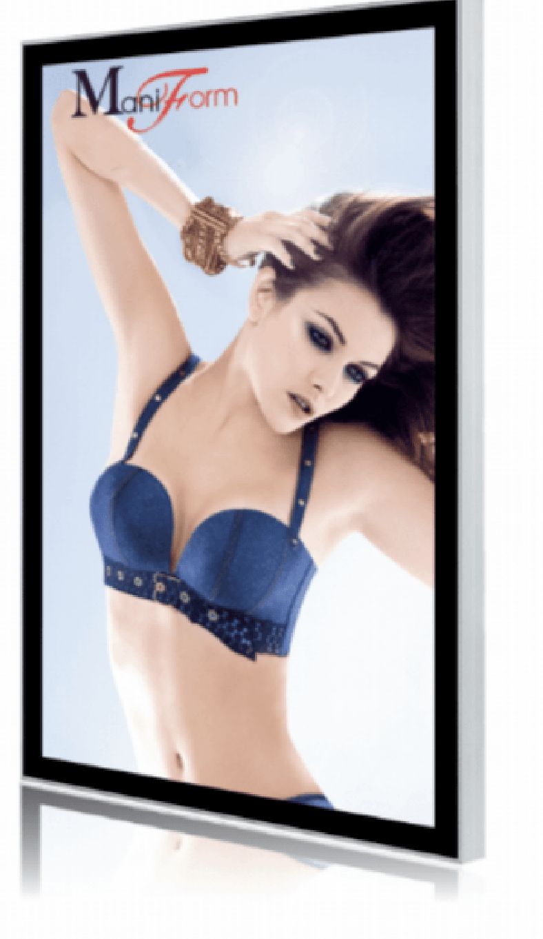 Woman in blue lingerie, arm raised, looking at the camera. Sunlight background. "Maniform" logo.