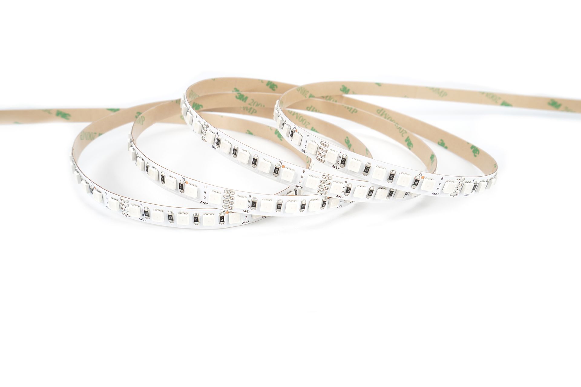 LED light strip rolled up with adhesive backing, white background.