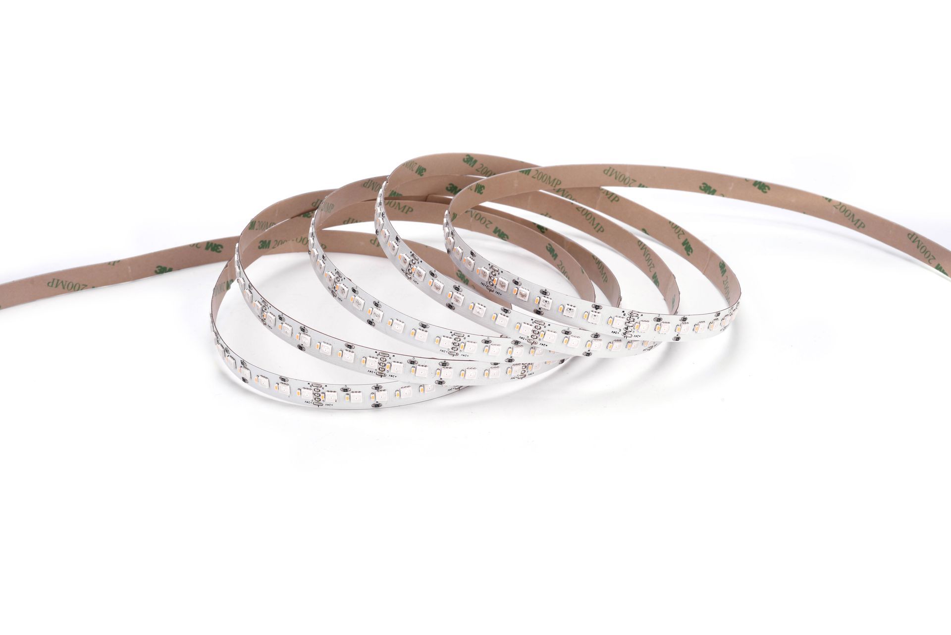 LED light strip coiled on a white surface, showing small, bright lights and adhesive backing.