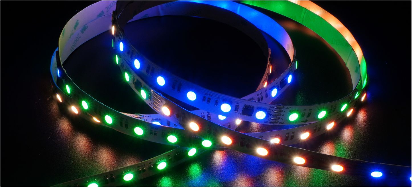 LED light strip emitting various colors on a dark surface.