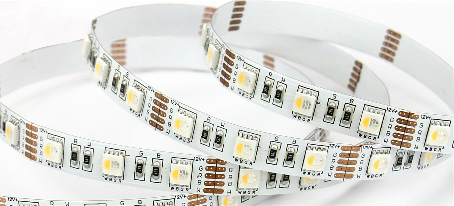LED strip lights coiled on a white surface, with a warm white glow.
