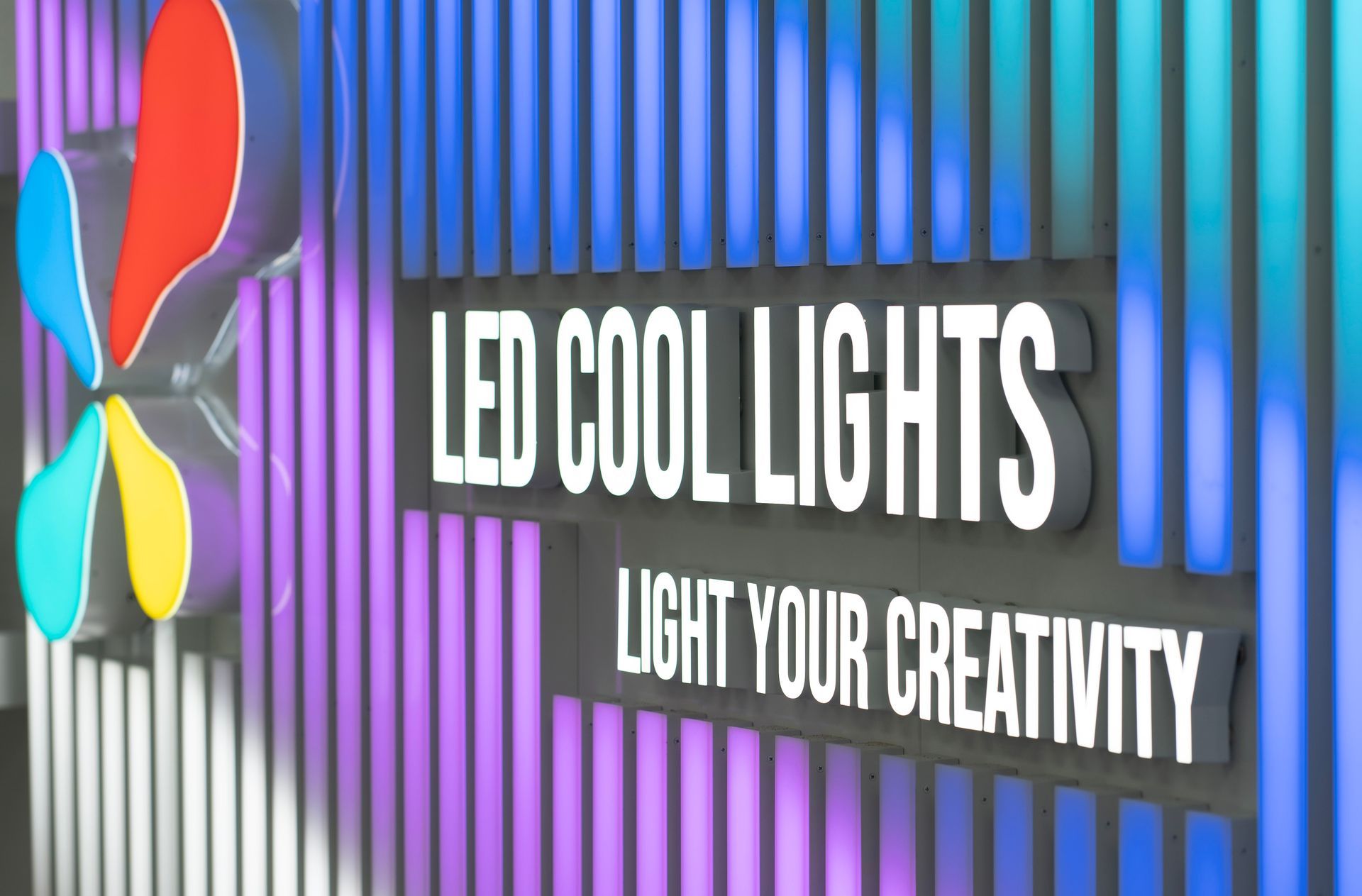 A sign that says `` led cool lights light your creativity '' on a wall.