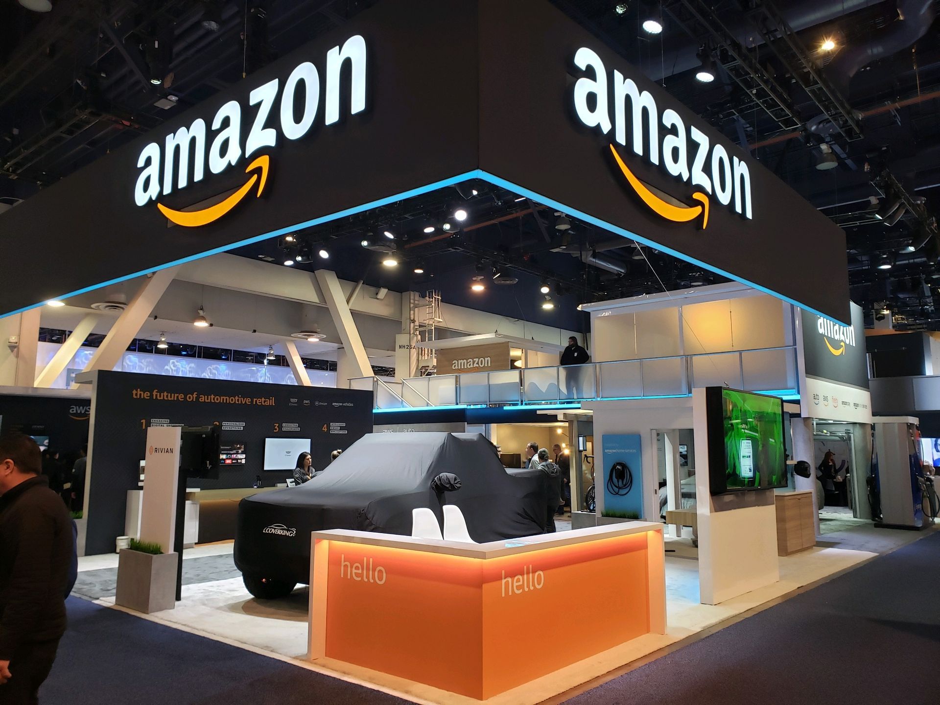 A man is standing in front of an amazon booth