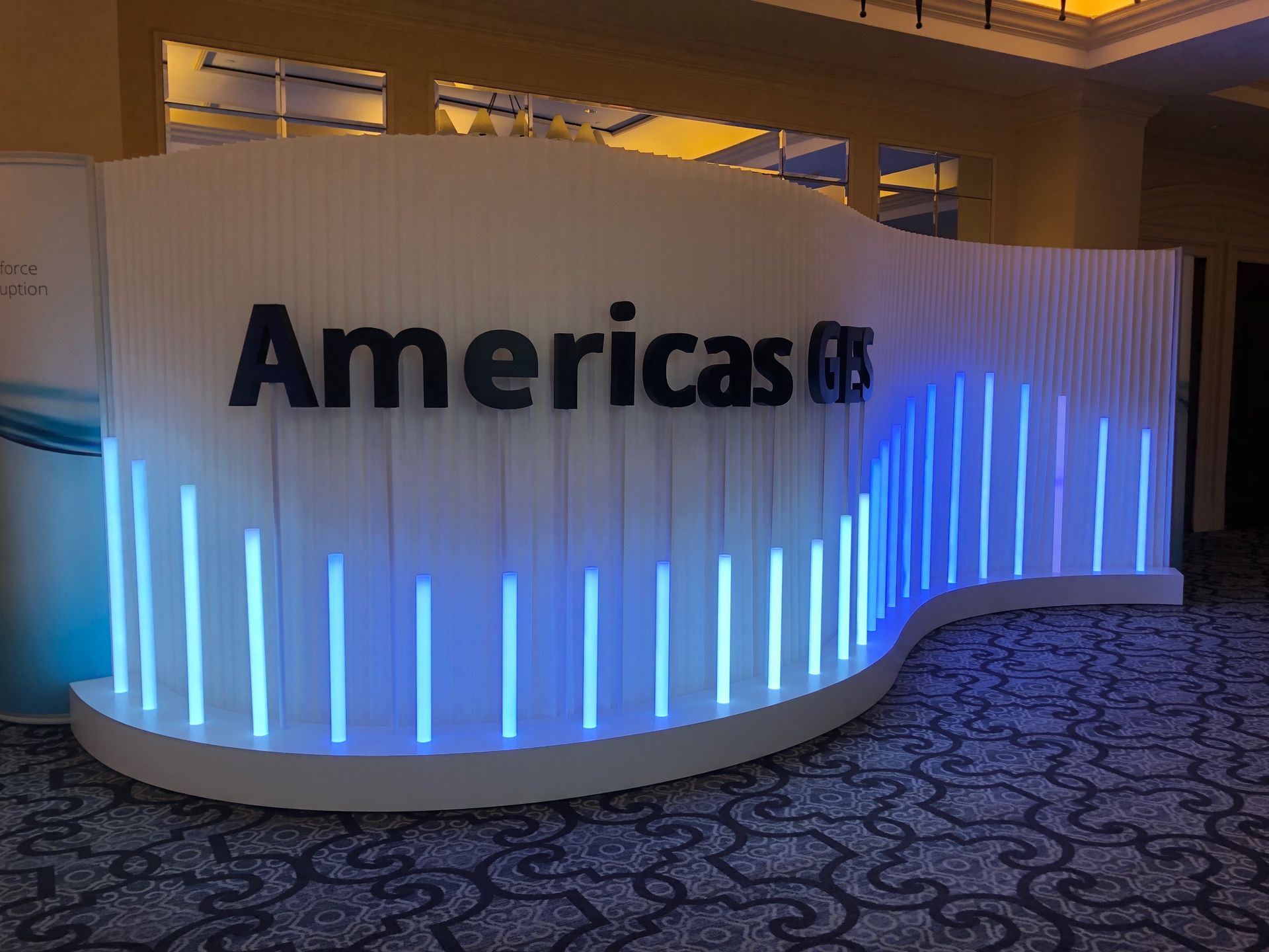 A sign that says americas is surrounded by blue lights