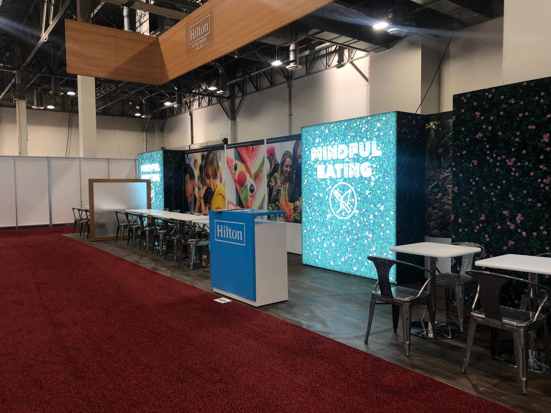 A large room with tables and chairs and a sign that says wonderful saturday