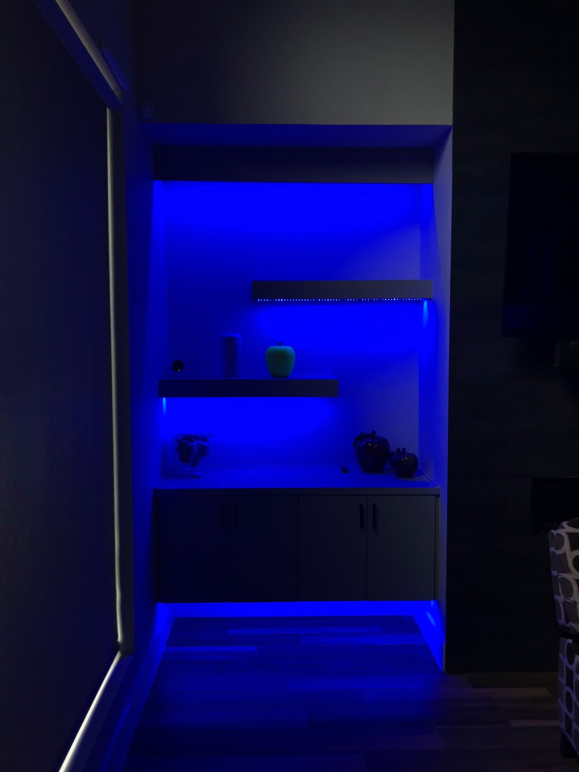 A dark room with blue lights on the walls