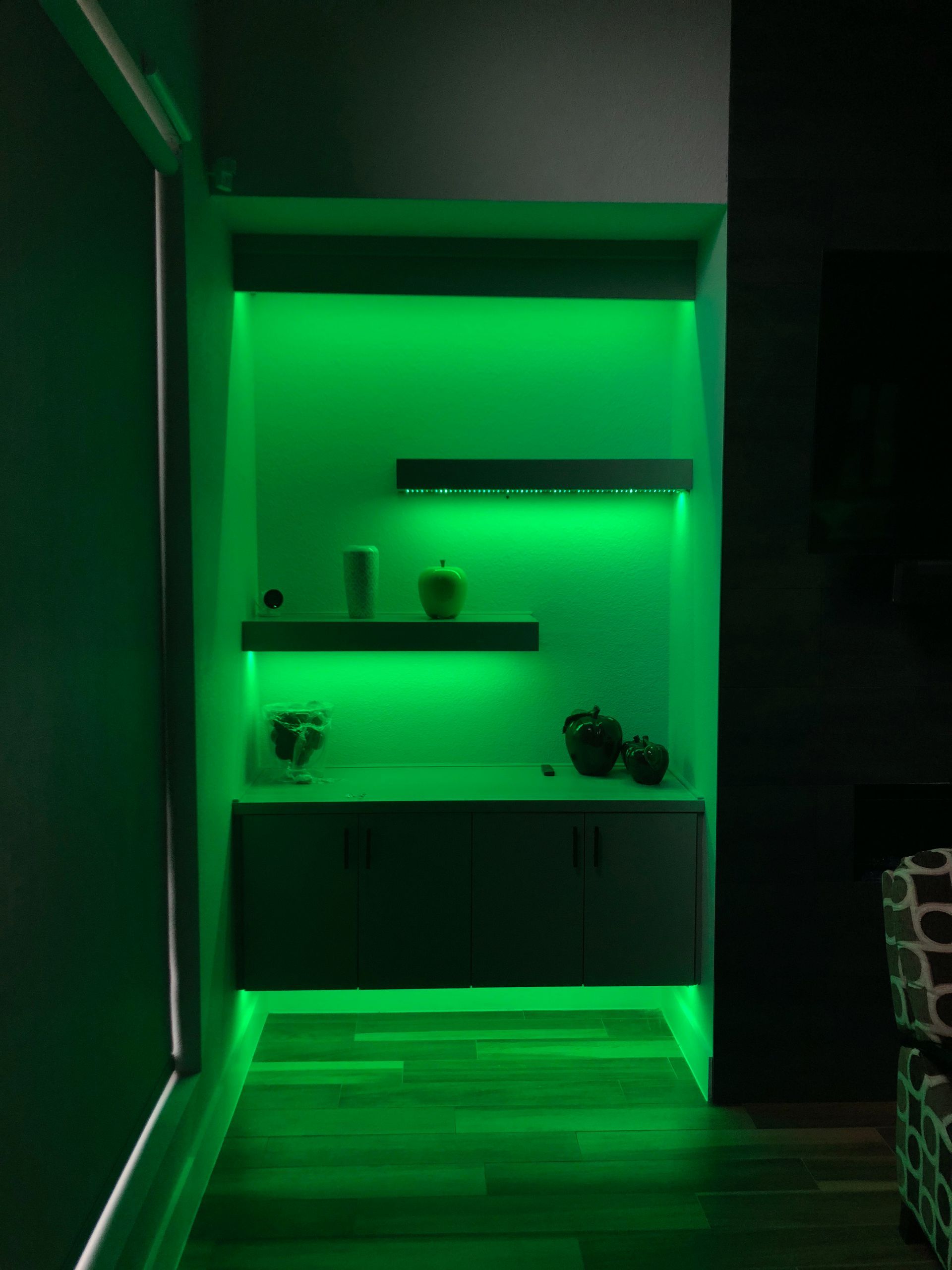 A dark room with green lights on the walls