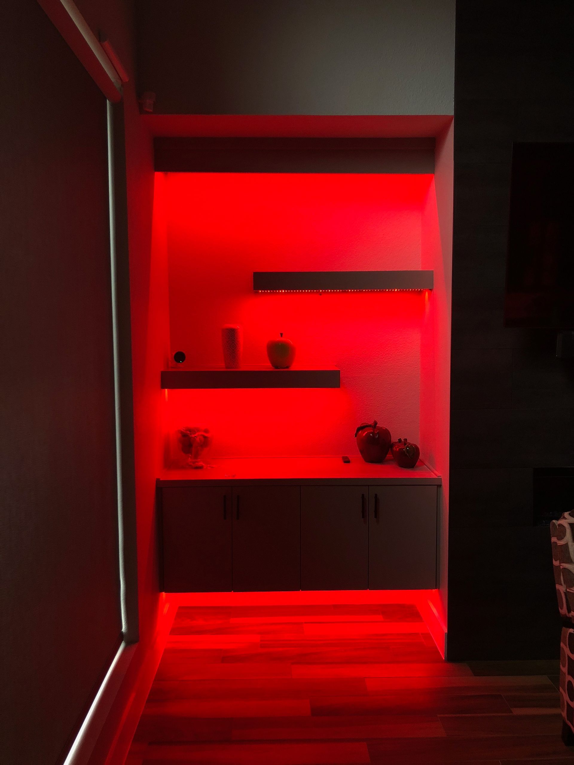 A dark room with red lights on the walls