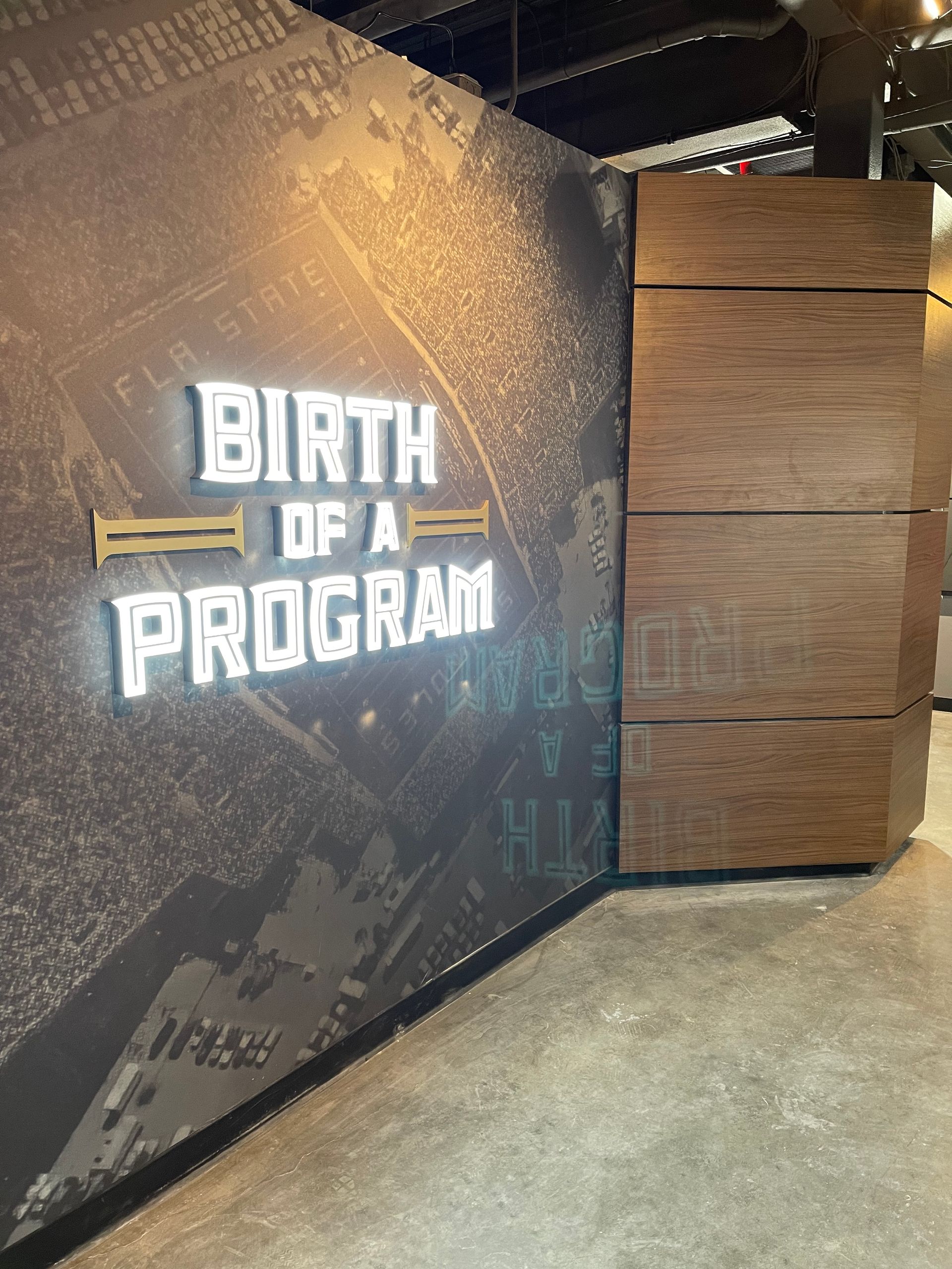A sign on a wall that says birth of a program