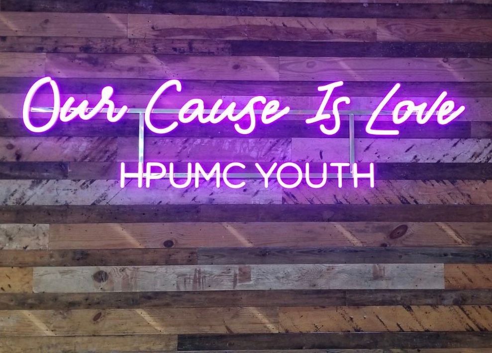 A Neon Sign that says Our Cause Is Love, HPUMC Youth