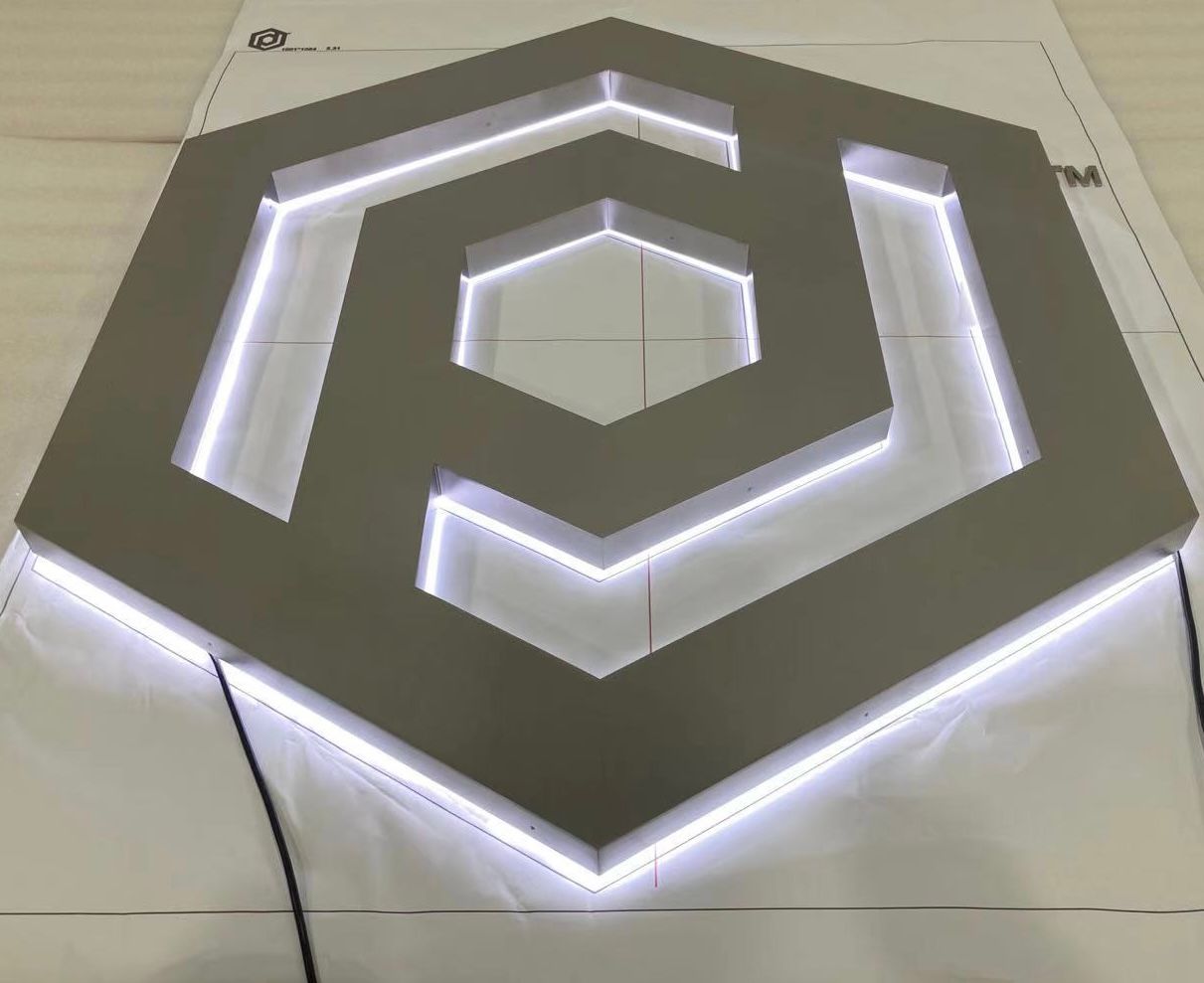 A silver hexagon with white lights on it is sitting on a table.