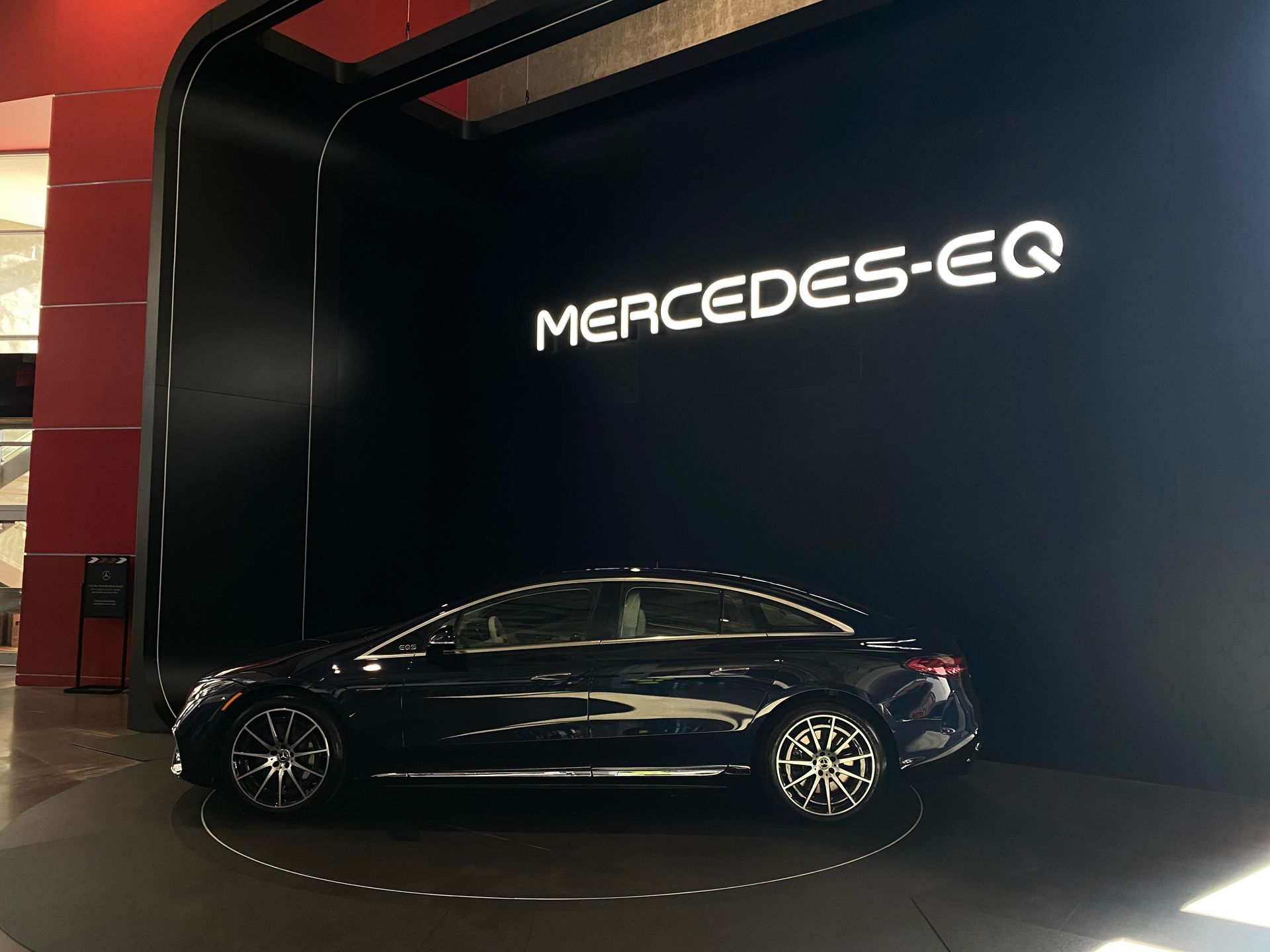 A mercedes eq is on display in a showroom