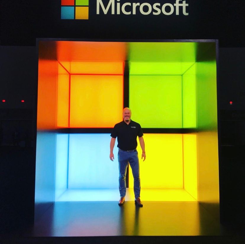 Massive Lit Up Microsoft Logo with man in front