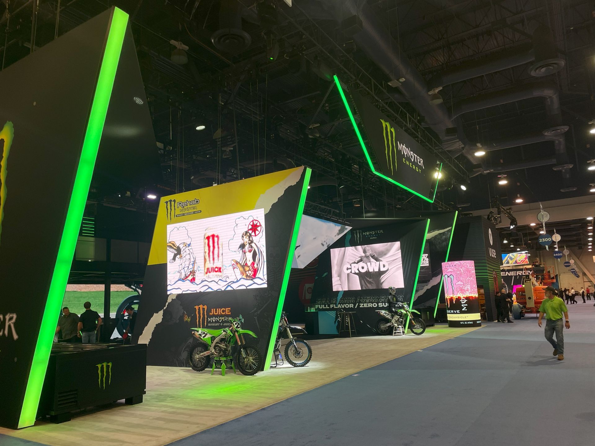 A monster energy display with motorcycles on display