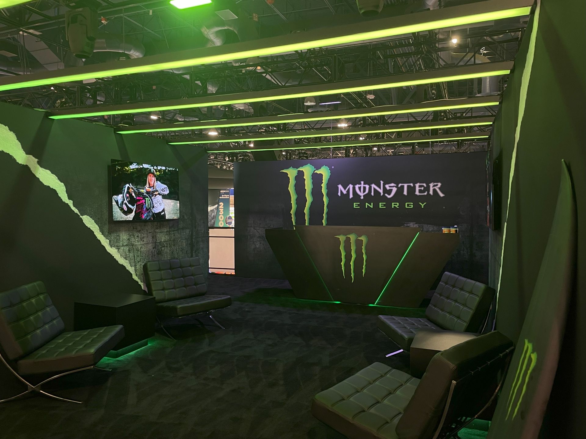 A room with a monster energy sign on the wall