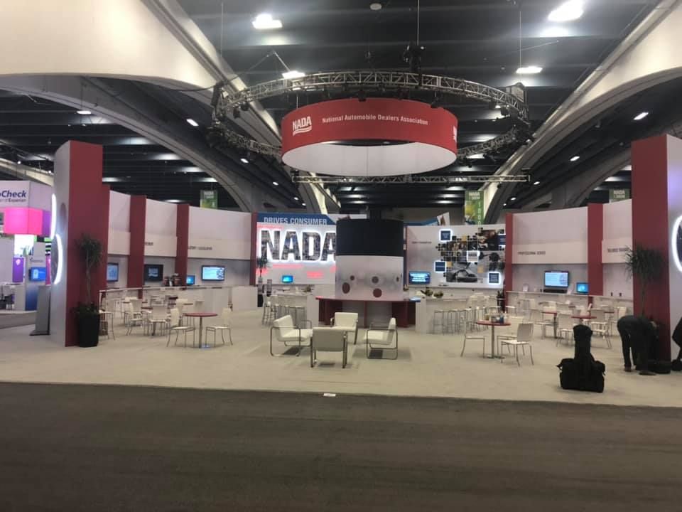 A large room with tables and chairs and a sign that says nada