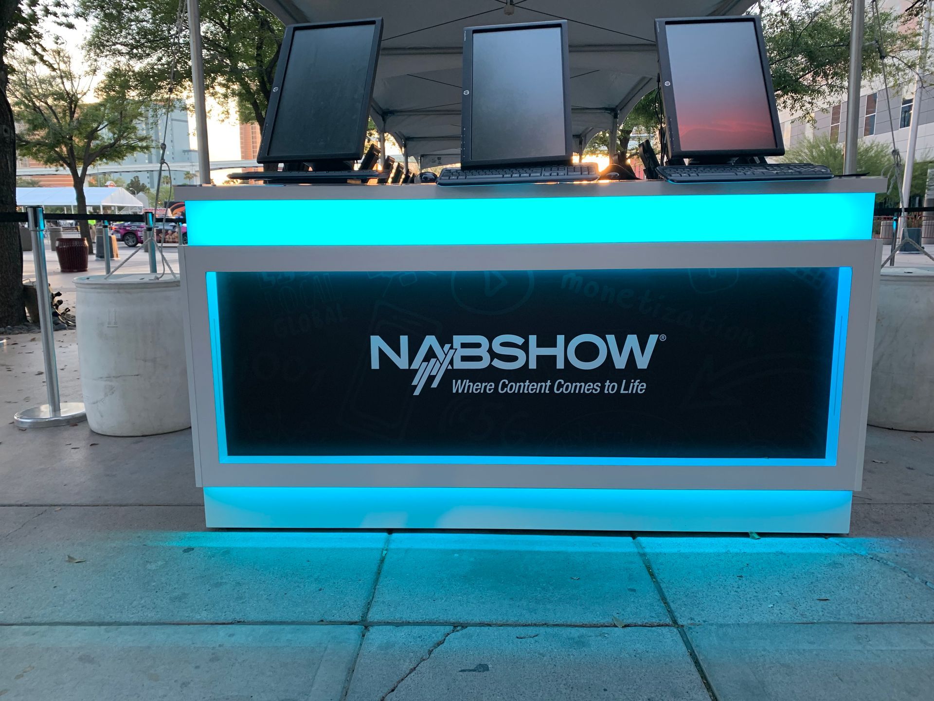 A nabshow sign is lit up with blue lights