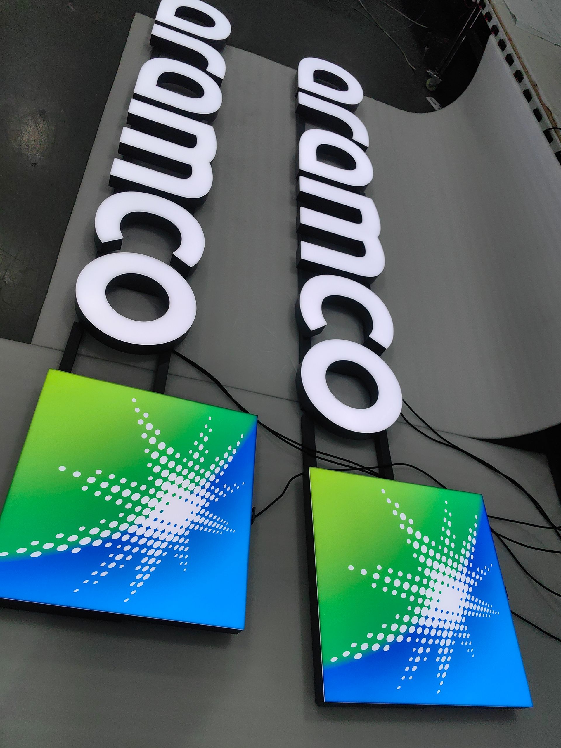 A couple of signs that say aramco on them