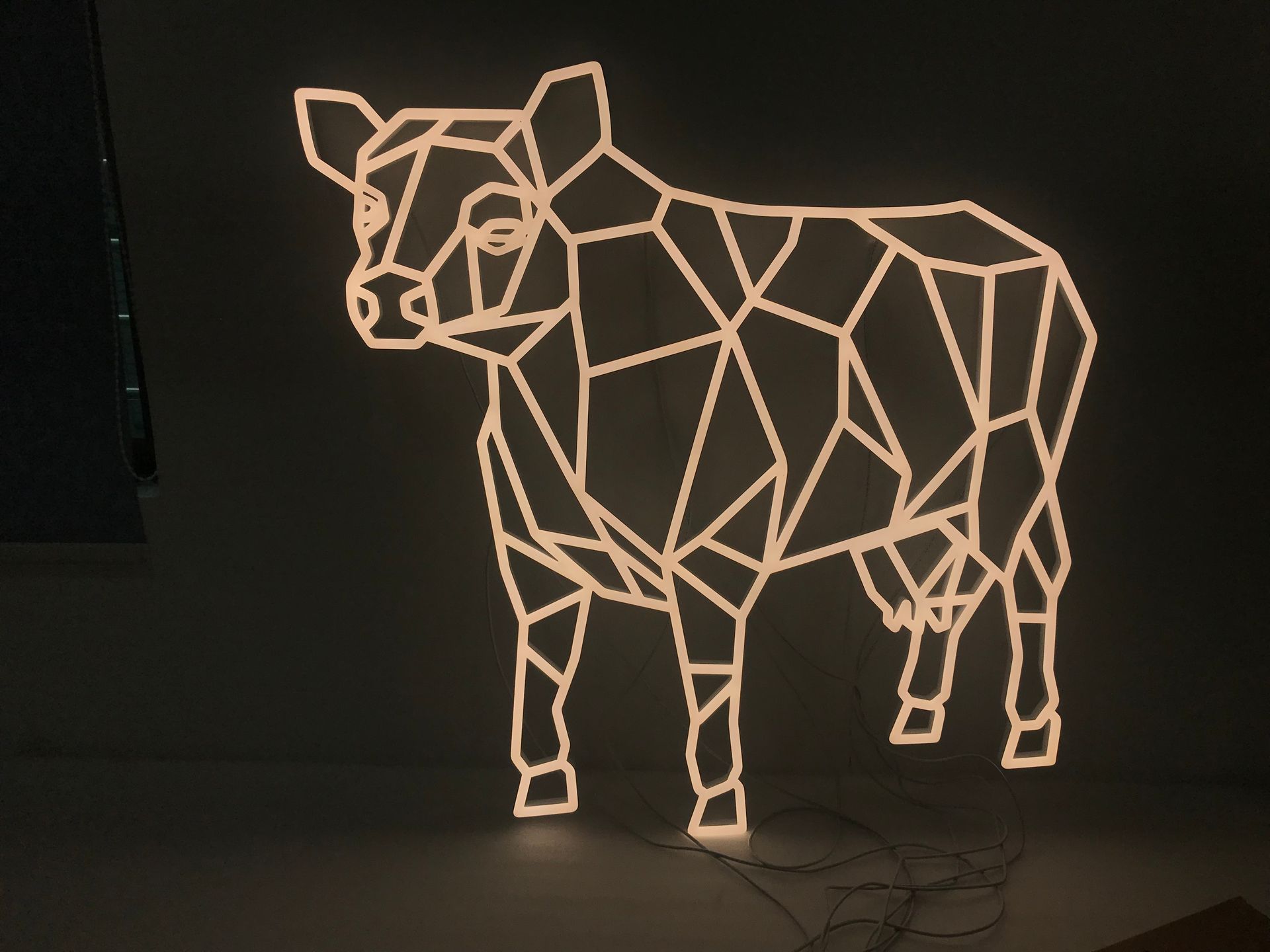 A custom LED sign that looks like a cow