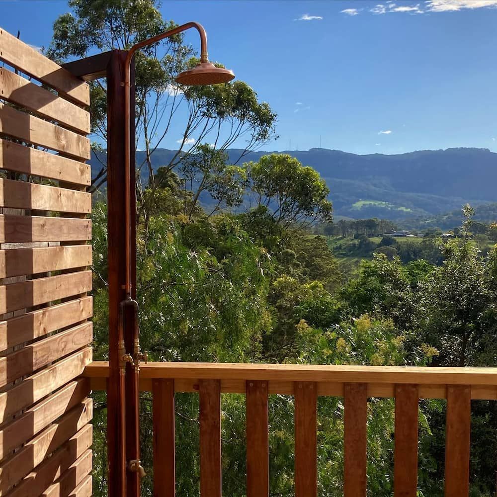 Outdoor Shower With Mountain View, Wooden Privacy Screen, and Railing — Corrimal Plumbing Services in Shellharbour, NSW