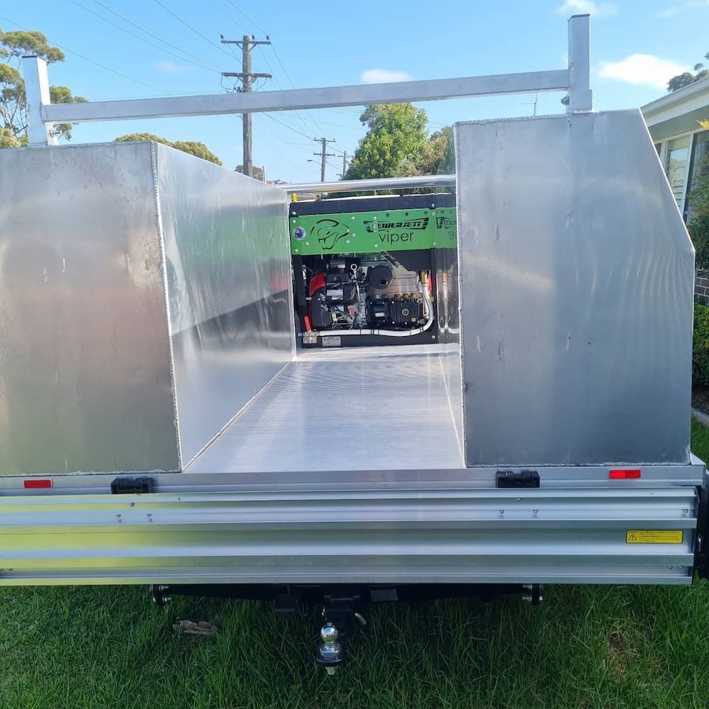 Aluminum Trailer Bed With a Green Generator Inside — Corrimal Plumbing Services in East Corrimal, NSW