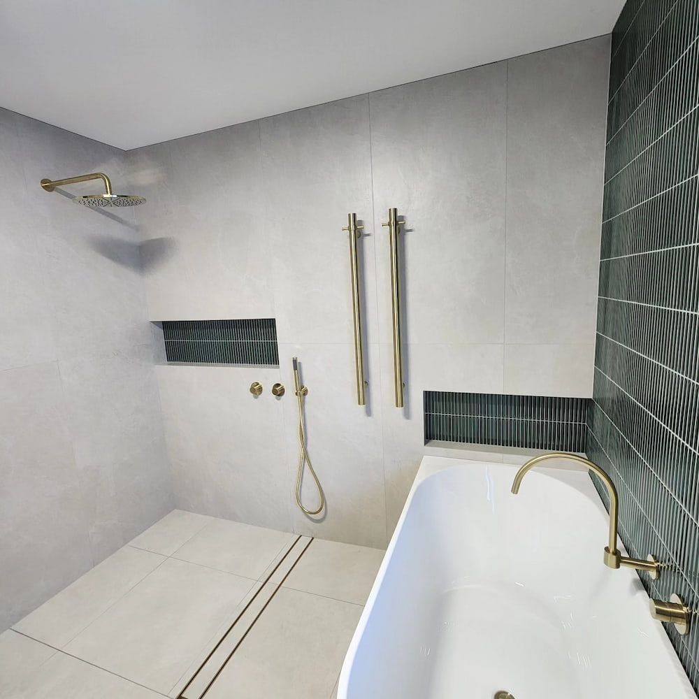 Modern Bathroom With Shower, Bathtub, and Green Accent Tiles — Corrimal Plumbing Services in East Corrimal, NSW